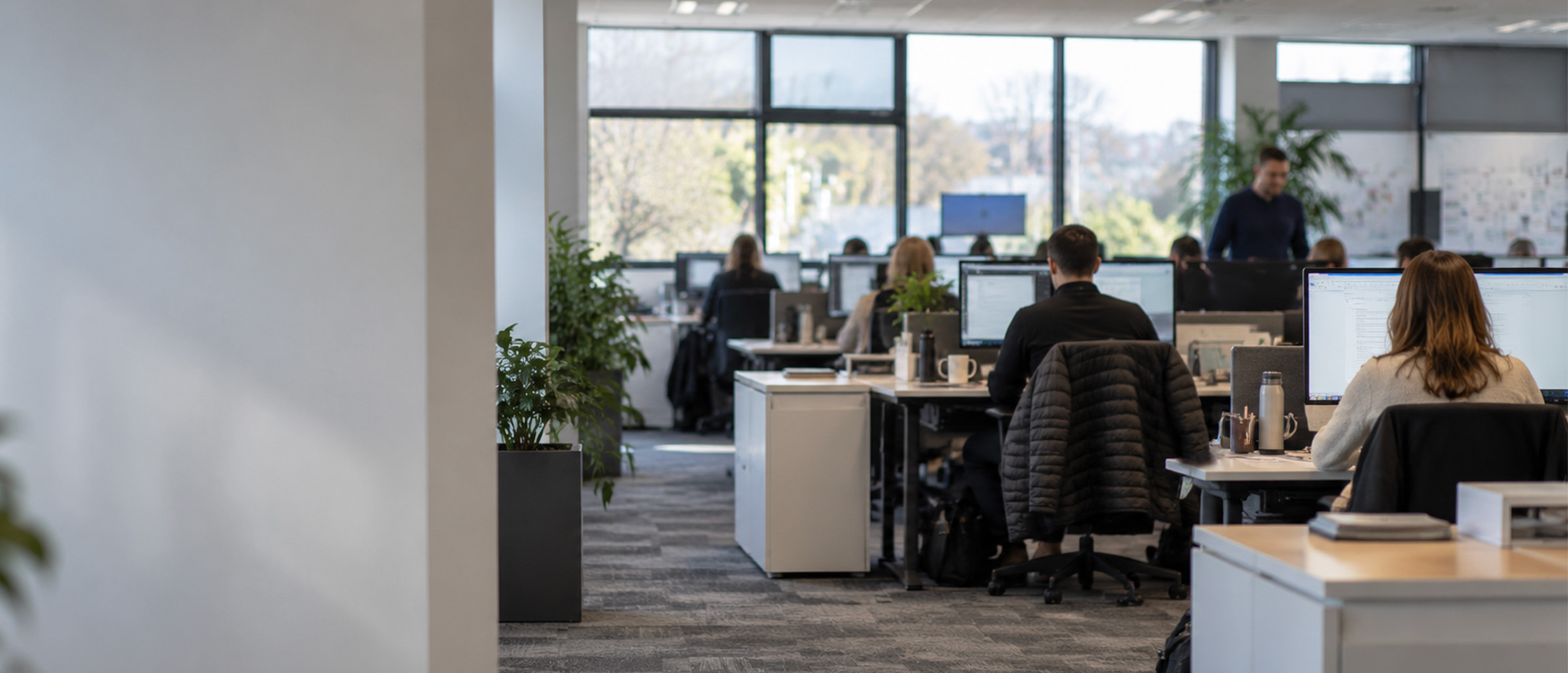 A modern office space with people working at their desks.