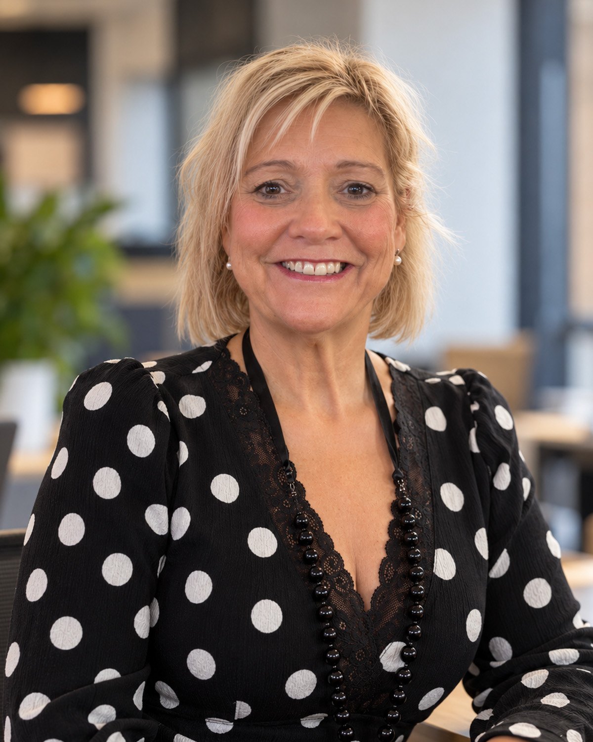 Tracey Darby, smiling, in an office.